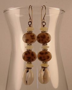 Animal Print Afrocentric Cowrie Shell African Earrings Tribal Bohemian Bronze Earrings With Round Beads, Beach Beaded Metal Earrings, Metal Beaded Earrings For Beach, Handmade Metal Beaded Earrings For Beach, Nickel-free Brown Beaded Earrings For Festival, Brown Round Bead Earrings For The Beach, Bohemian Brown Beaded Nickel-free Earrings, Adjustable Bohemian Beaded Metal Earrings, Bohemian Beaded Earrings With Round Metal Beads