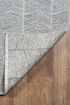 an area rug with wood flooring on top of it and a wooden floor in the background