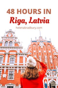 a woman standing in front of a building with the words 48 hours in riga, lavr