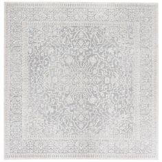 a gray and white rug with an intricate design on the bottom, in front of a white background