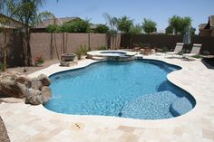 a backyard with a pool and patio furniture