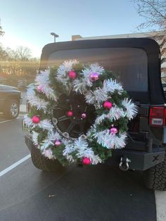 the truck is decorated with pink and white ornaments