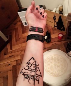 a person with a wrist tattoo on their arm