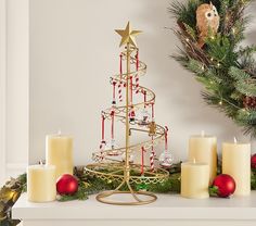 a christmas tree with candles and ornaments around it