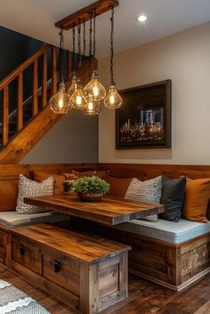 a wooden bench sitting under a stair case next to a table with two benches underneath it