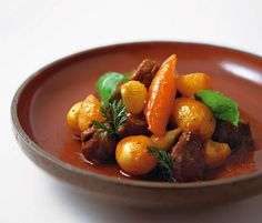 a plate with some food on it and garnished with green leafy leaves