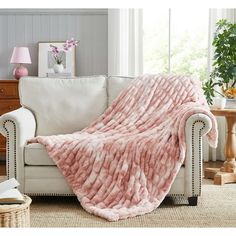 a couch with a pink blanket on top of it