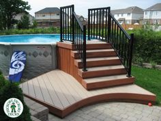 an above ground swimming pool with steps leading up to it and a deck next to the pool