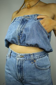 "Levi's denim jeans turned crop top. This upcycle features medium wash denim synched with elastic at the hem while the back displays a clear panel to show some skin. The jeans were originally size 6 but after adding the clear panel the \"waist\" measures 32.5in & bust area measures 40in. Fits like a medium." Light Wash Stretch Cropped Bottoms, Stretch Cropped Denim Jeans, Light Wash Cropped Bottoms With Pockets, Cropped Light Wash Bottoms With Pockets, Light Wash Cropped Denim Bottoms, Stretch Denim Cropped Crop Top, Dark Wash Denim Crop Top, High Waist Denim Crop Top In Medium Wash, Light Wash Cropped Denim Crop Top