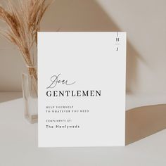 a card with the words ben gentelmen on it next to a vase filled with dry grass