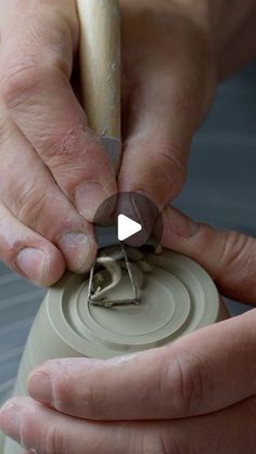 a person holding a piece of pottery in their hands