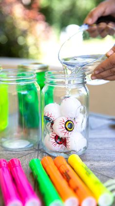 pouring water into a jar filled with eyeballs How Many Eyeballs In The Jar, Diy Potion Bottles Halloween Dollar Tree, Jar Of Eyes Halloween, Eyeball Jar Halloween, Eyeball Halloween Decorations Diy, Pick Or Treat Frankenstein, Halloween Mason Jars Treats, Eyeballs In A Jar Halloween, Creepy Science Lab