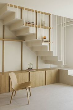 a chair sitting on top of a white floor next to a stair case