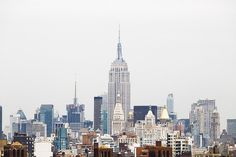 a city skyline with tall buildings in the background