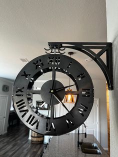 a large metal clock hanging from the side of a wall