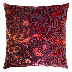 a purple and red pillow with an intricate design