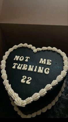 a heart shaped cake with the words not me turning 22 written on it in white frosting