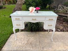 a white desk sitting on top of a sidewalk