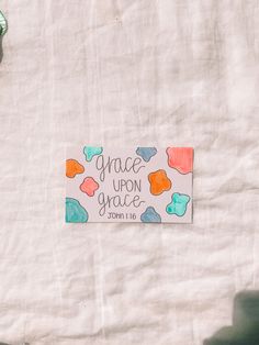 a paper sign that says grace upon grace on the side of a white sheeted wall