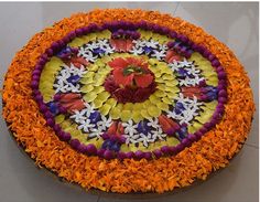 a cake decorated with orange and purple flowers