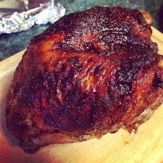 a piece of meat sitting on top of a wooden cutting board