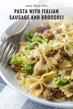 a white bowl filled with pasta and broccoli on top of a checkered table cloth