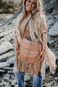 The Lia Saddlebag is truly UNFORGETTABLE. This bag was made to go with you on all of your greatest adventures, featuring a gorgeous full fringe design, ample storage, edgy bronze chain link strap, zipper closures, genuine leather, and braided detail. Vegetable tanned leather 18" (L) X 13" (W) 1 inner zip pocket, 2 slip pockets Fringe detail on bag and zippers Easily accessable pull through closure design Adjustable strapsThis item is a part of our Down To Earth Collection. This earth toned colle Full Fringe, Closure Design, Pull Through, Greatest Adventure, Vegetable Tanned Leather, Saddle Bags, Tan Leather, Chain Link, Bucket Bag