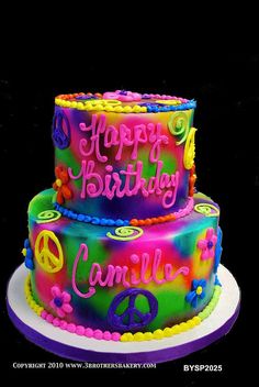 a three tiered cake decorated with peace signs and the words happy birthday danielle on it