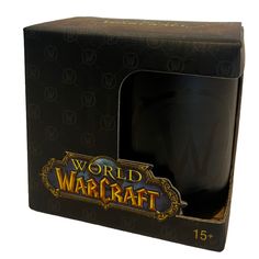 a black mug in a cardboard box on a white background with the words world of warcraft printed on it