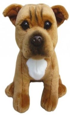 a brown and white dog stuffed animal sitting on top of a table