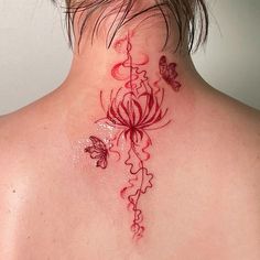 a woman's back neck tattoo with red flowers and butterflies on her left side