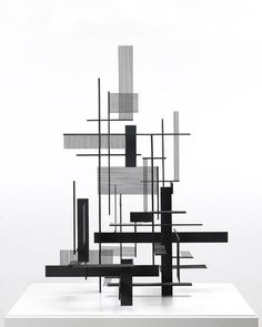 an abstract black and white sculpture sitting on top of a table