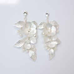 New to our Millennium Bride Collection These Beautiful Romantic Swarovski Flower Petals Crystal Earrings are made of very fine quality of Swarovski Crystals, Pearl, Rhinestones and beautifully made metal flower and leaves for your special day! Even we have hard time taking pictures because of their shine 😄 so we want to shine our brides on their special days. The material used in these earrings are free from Lead, Nickel, Cadmium so it will not give you any skin irritation and environment frien Wedding Crystal Flower Earrings, Crystal Flower Earrings For Wedding, White Flower Shaped Crystal Earrings For Wedding, White Flower Crystal Earrings For Wedding, White Flower-shaped Crystal Earrings For Wedding, Silver Flower Pearl Earrings For Wedding, Silver Flower Drop Earrings For Wedding, White Crystal Flower Earrings For Wedding, Silver Dangle Earrings With 3d Flowers