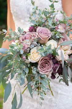 a bride holding a bouquet of roses and greenery on her wedding day with instagrams