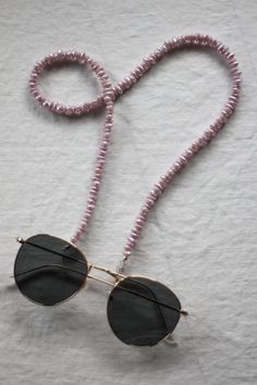 Lilac has been *such* a trendy colour this year and this set of glasses chains is the perfect lilac shade with a pearly finish! We love the unique shape of these beads too!  24" long  Sunglasses chains are back and trendier than ever before! All of our sunglasses/glasses chain are made using vintage beads from reclaimed necklaces! We love that we are able to rework them into something modern and fun! They're like jewellery for your glasses! These sunglasses chains are built to last using strong Handmade Glasses Chains For Summer Party, Handmade Summer Party Glasses Chains, Trendy Handmade Glasses Chains For Party, Trendy Adjustable Glasses Chains For Party, Summer Party Beaded Glasses Chains, Elegant Purple Necklaces For Beach, Elegant Purple Necklace For The Beach, Elegant Purple Necklace For Beach, Adjustable Purple Glass Glasses Chains