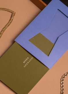 an open envelope and chain on a table