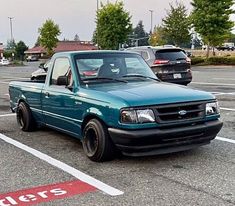 a blue pick up truck parked in a parking lot