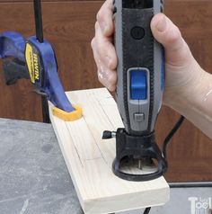 a person using a power tool on a piece of wood