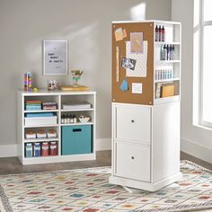 a room with a white cabinet and various crafting supplies on the shelf next to it