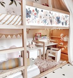 there is a bunk bed with flowers on the wall and other furniture in the room