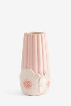 a pink vase with white flowers on the inside and bottom, against a white background