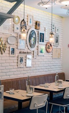 a restaurant with white brick walls and tables