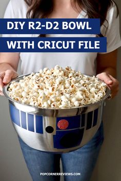 a woman holding a bowl full of popcorn with the words diy r2d2 bowl