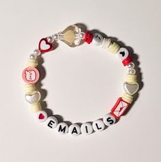 a white bracelet with red, white and blue beads that says email is on it