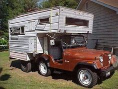 an old jeep with a camper attached to it's bed is parked in front of a house