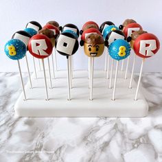 there are many cake pops with different designs on them, and one is for the letter r