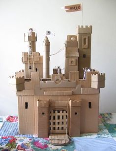 a castle made out of cardboard sitting on top of a bed