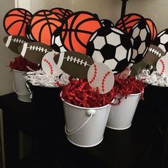 buckets filled with paper balls and decorations for a sports themed baby's first birthday