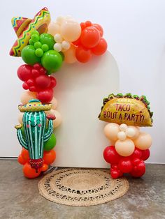 balloons and decorations are arranged in the shape of an arch for a mexican themed birthday party