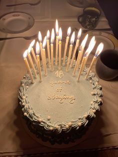 a birthday cake with lit candles on it